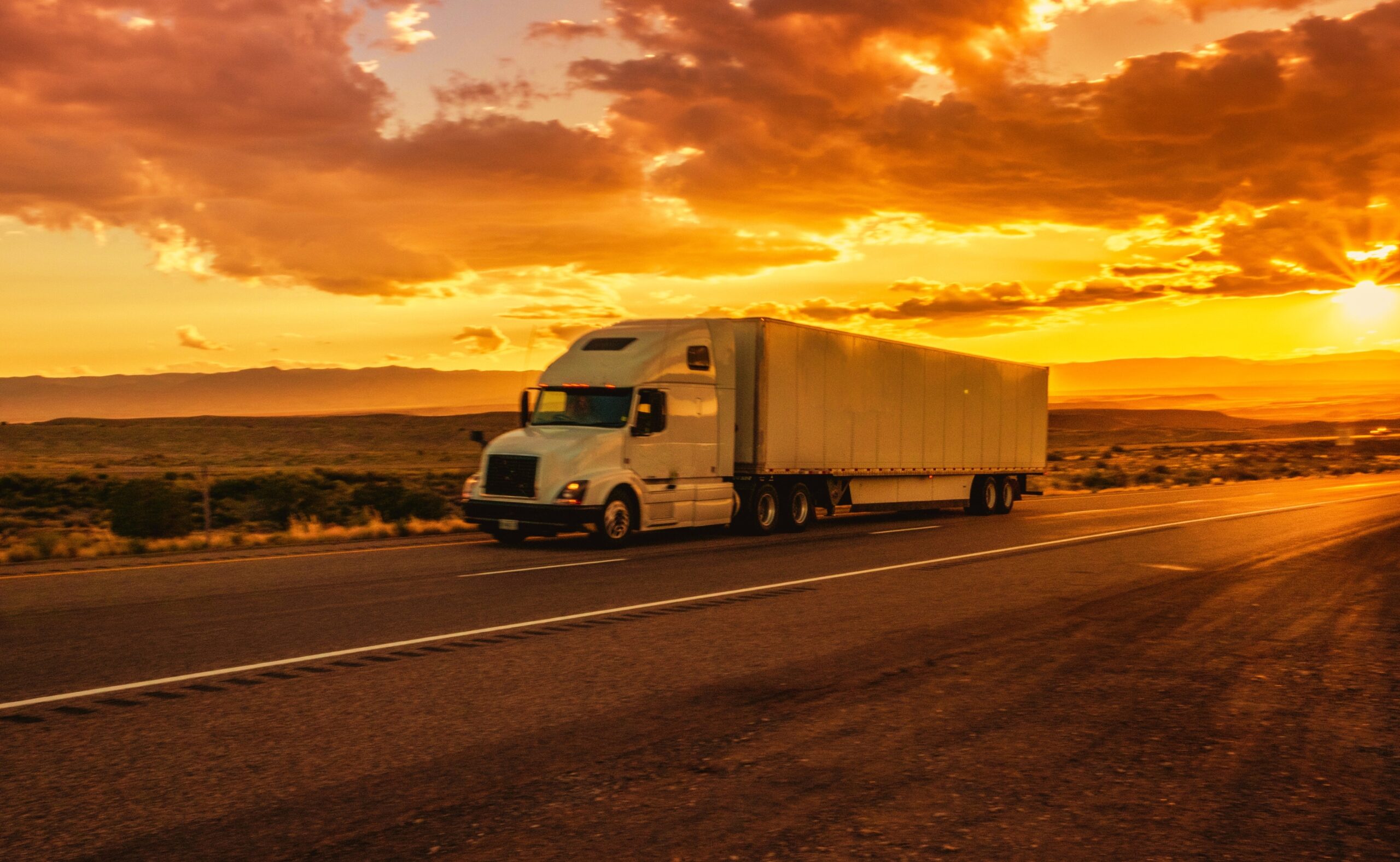 Semi-Truck on an Interstate Highway at Dusk with Cloudscape