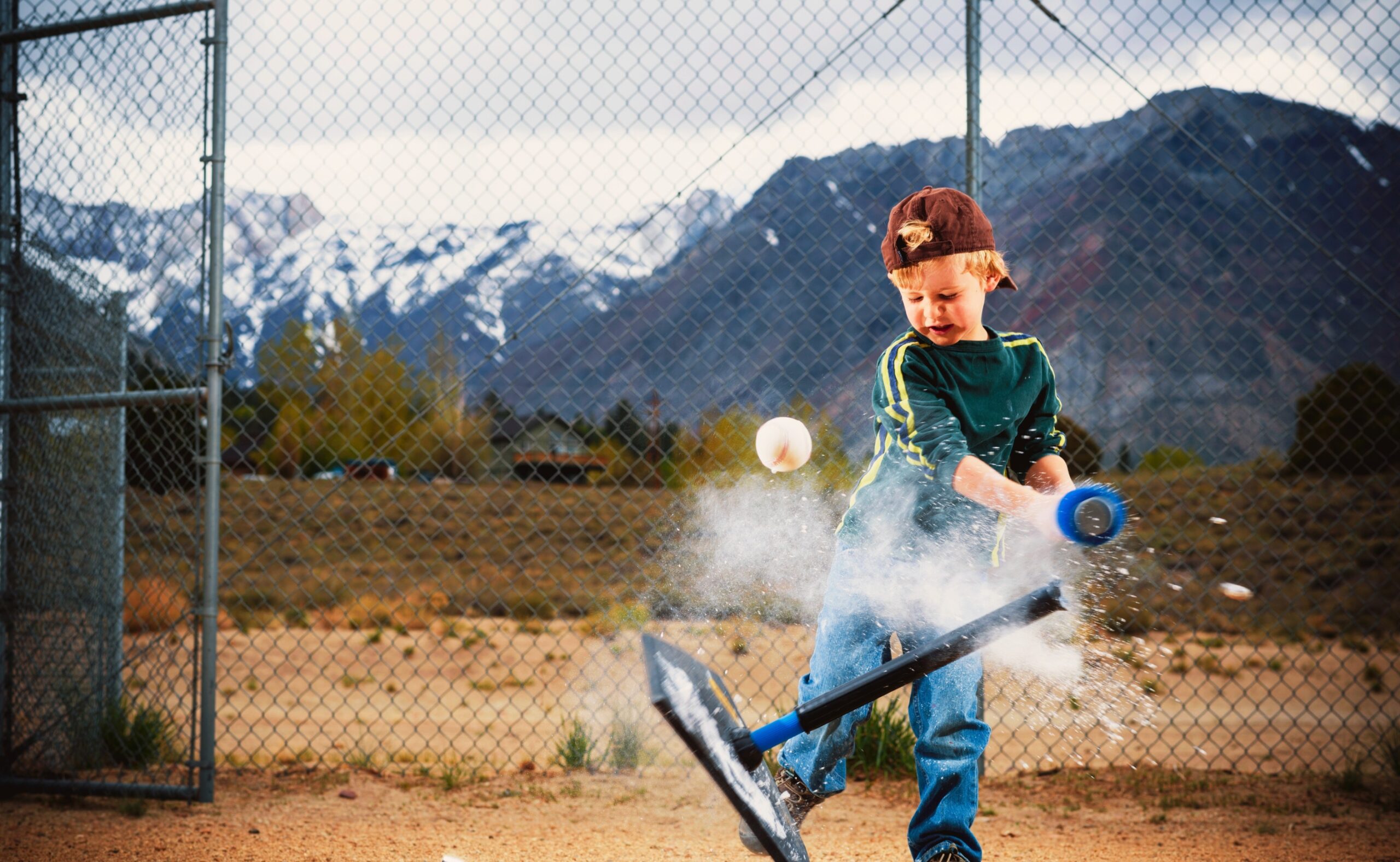child hitting a ball off a t-ball stand