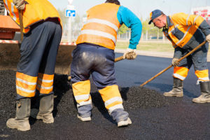 Construction workers during asphalting road works