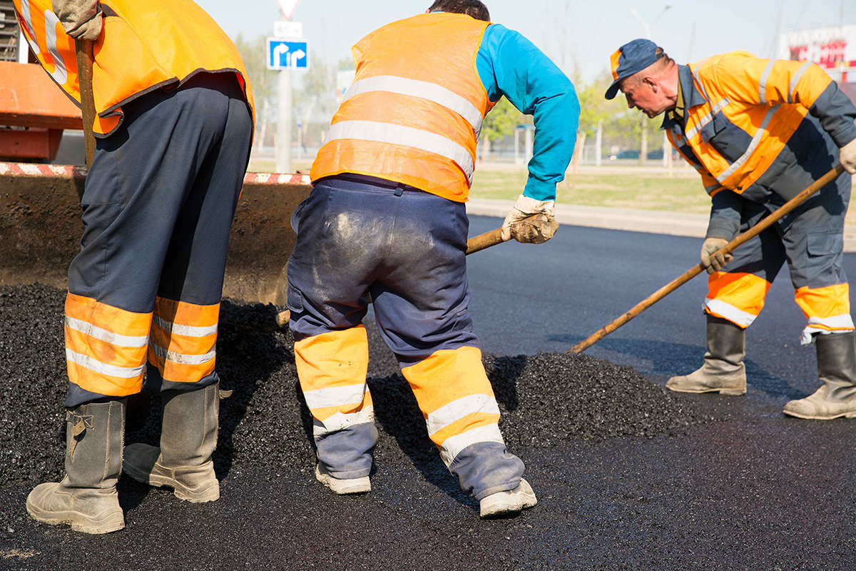 Construction workers during asphalting road works