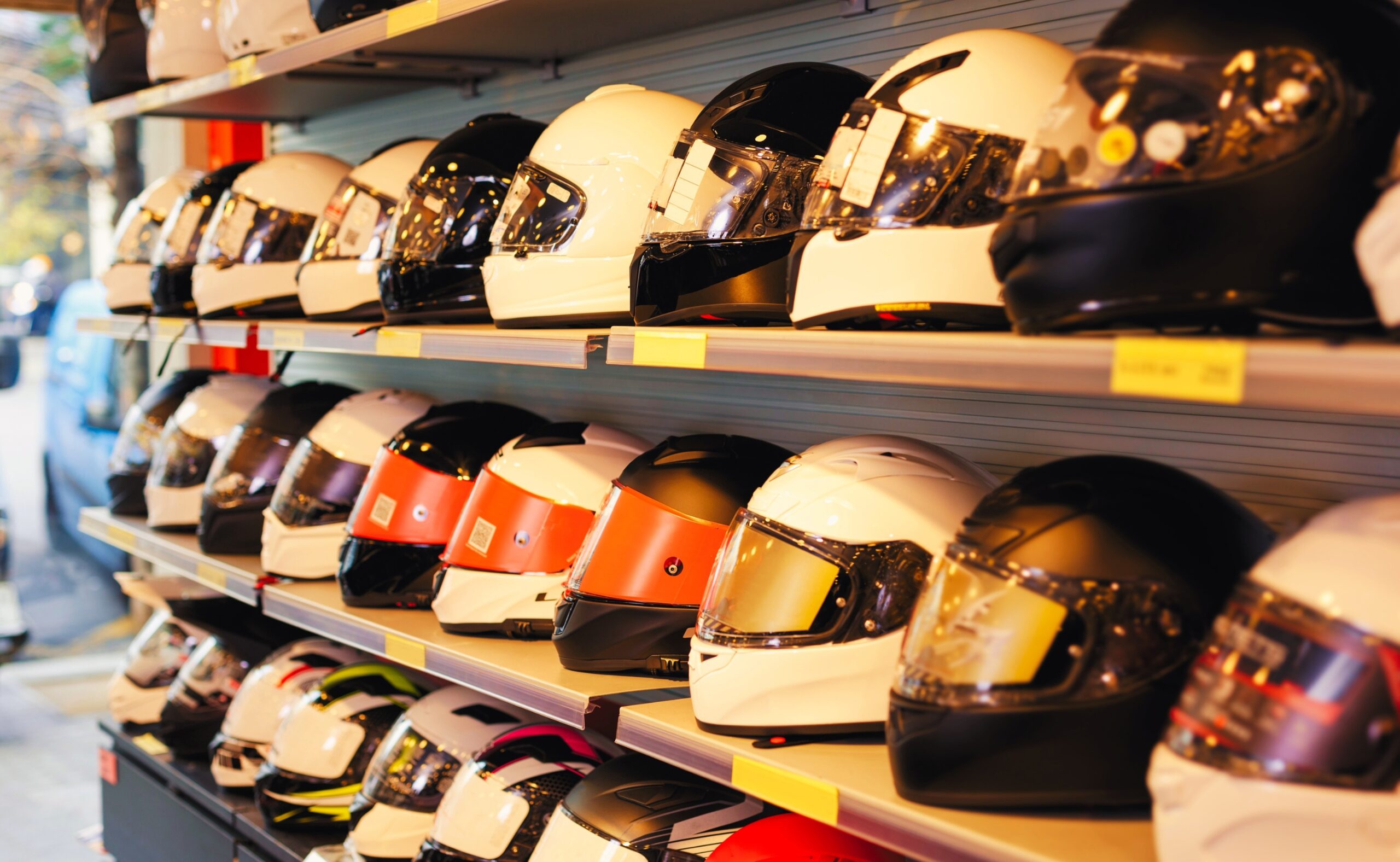 different helmets for sale in modern salon of motorcycle riding gear