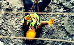 construction worker wearing safety vest and yellow helmet falls on site