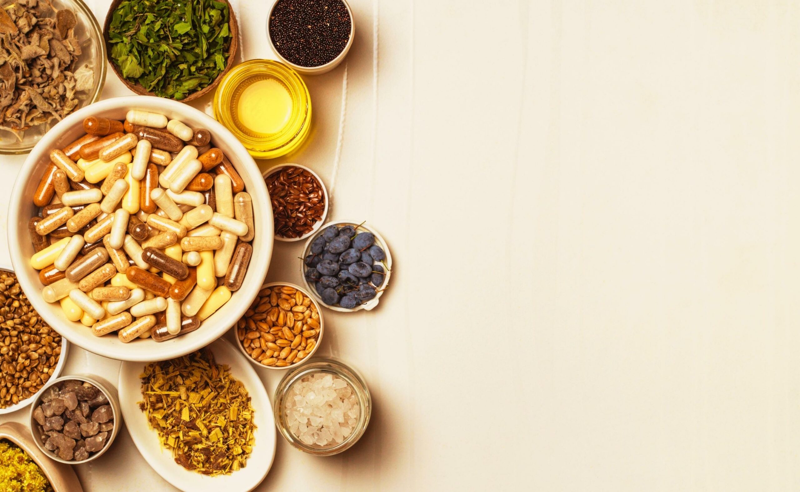 Capsules with dietary supplements. Ingredients for food supplements, minerals, oils and herbs in plates