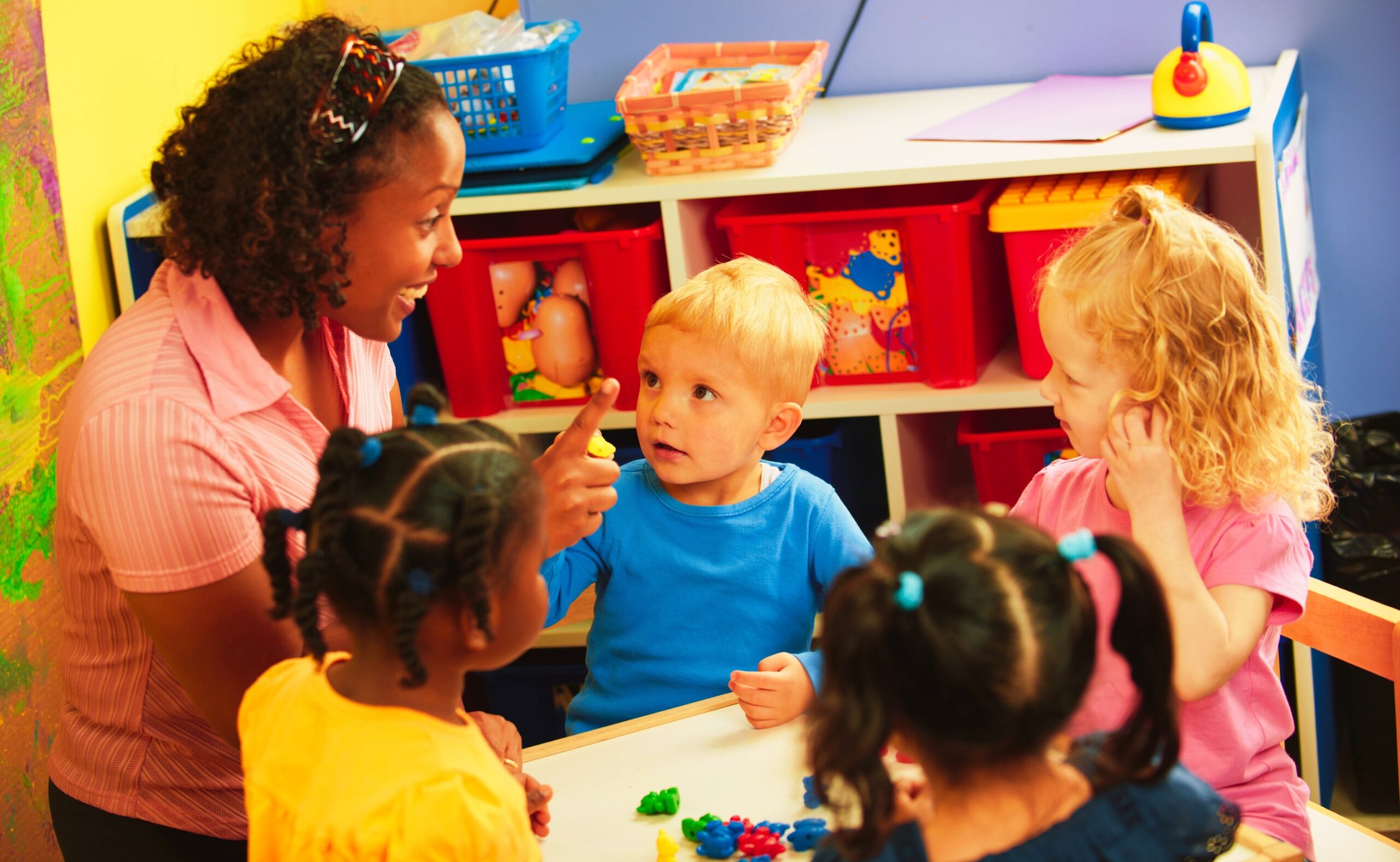 kids with their preschool teacher in daycare