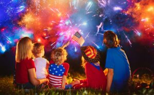 American family celebrating independence day with fireworks on 4th of July