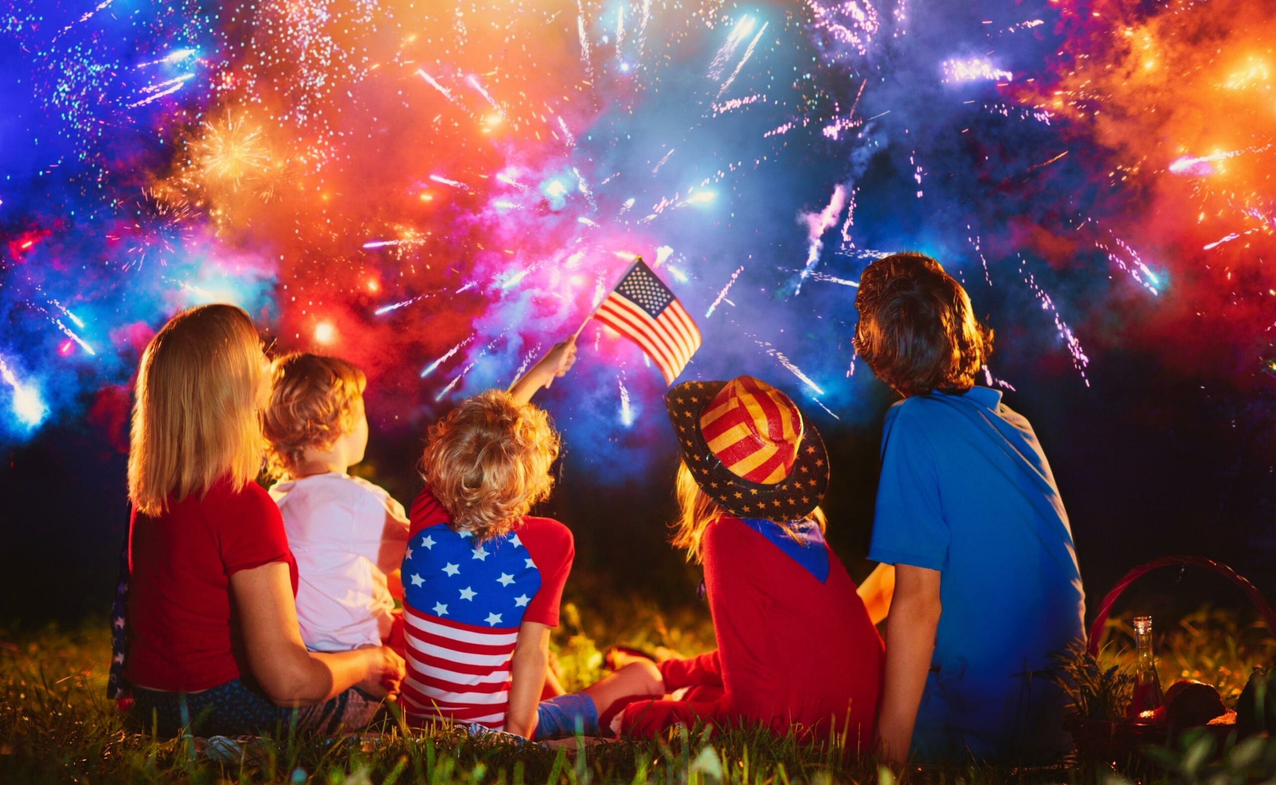 American family celebrating independence day with fireworks on 4th of July