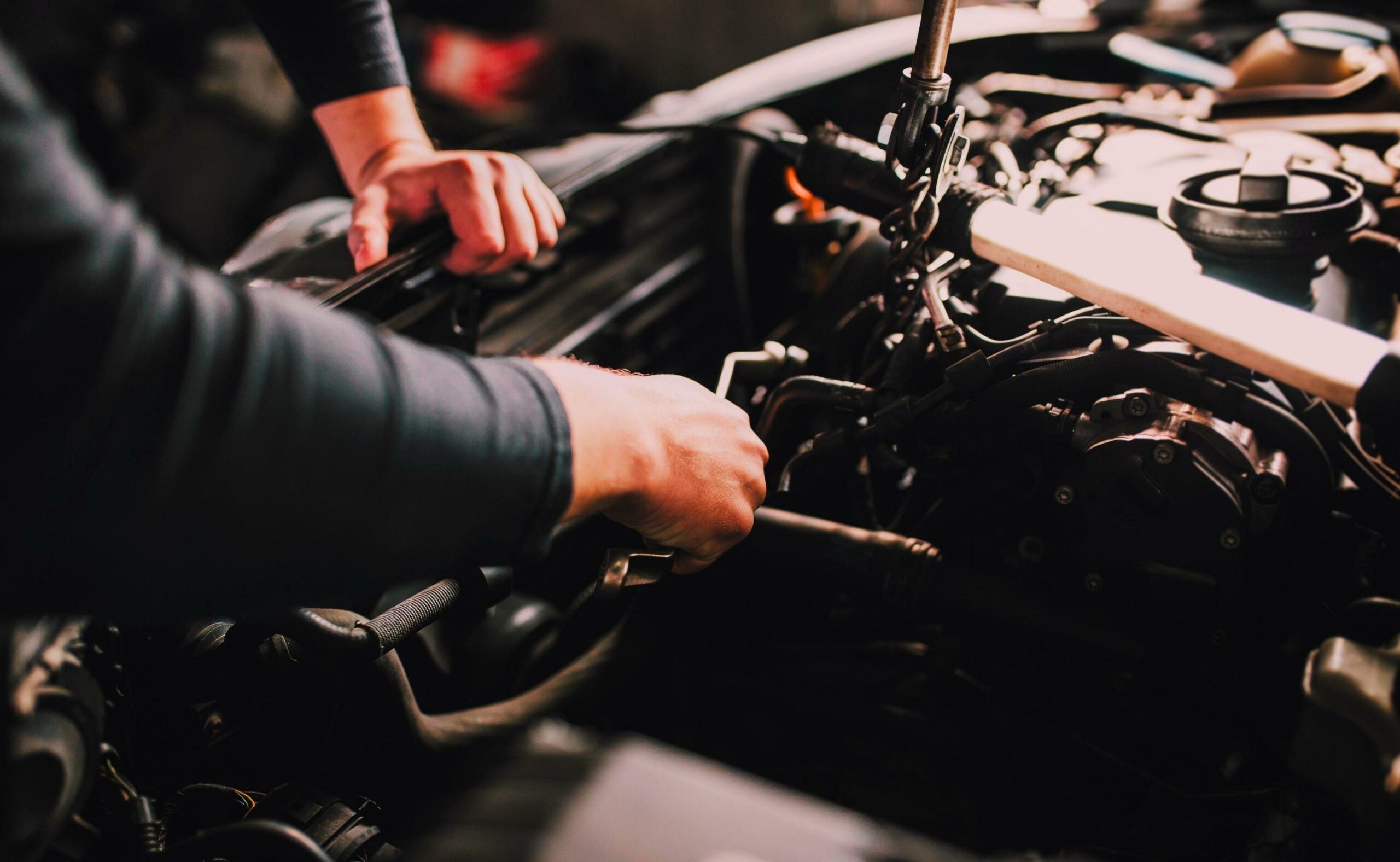Auto mechanic working on the engine