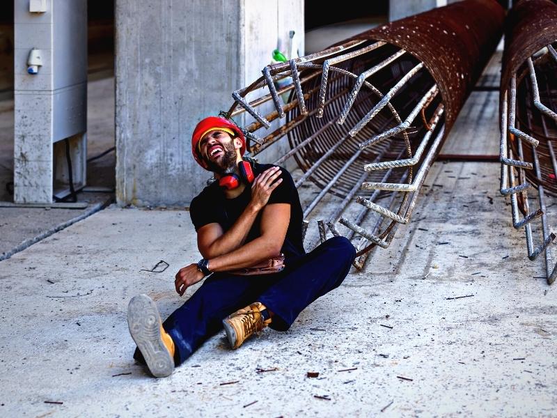 A Young Construction Site Worker has an Accident at Work.