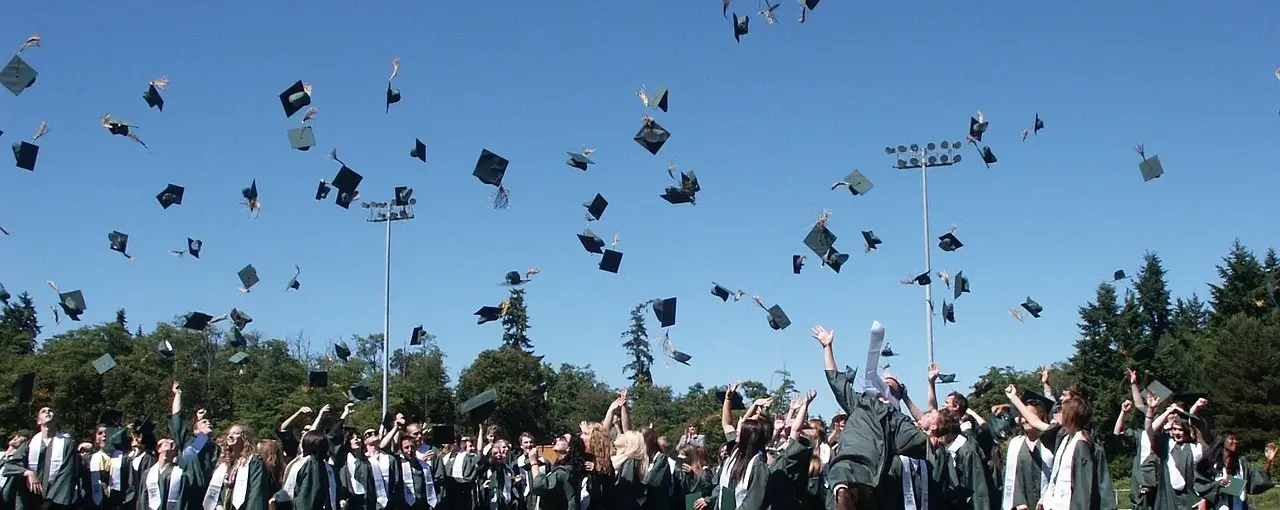 graduation hats tossed in air