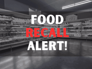 Cropped image of woman pushing trolley in aisle in supermarket with food recall alert texts.