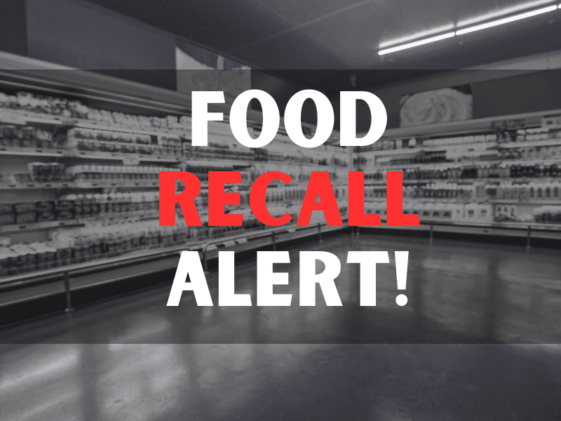 Cropped image of woman pushing trolley in aisle in supermarket with food recall alert texts.