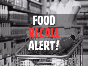 Defocused blur buying milk put on shelf in supermarket with food recall texts.