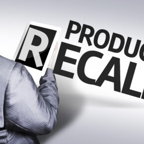 Product recall with a man in suit holding the letter "R" on a tablet device.