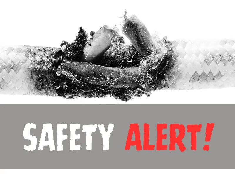 Burnt cable wire with safety alert text.