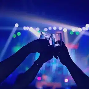 People raising and clinking their drink glasses together in a toast. Nightclub & Bar Security Assaults