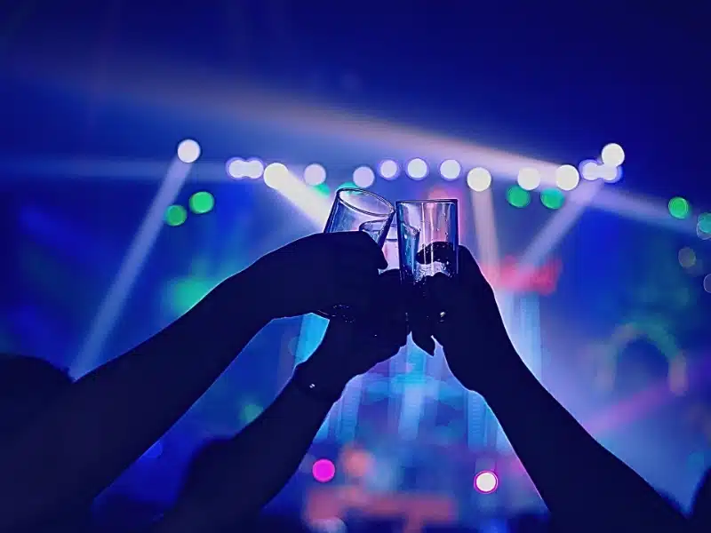 People raising and clinking their drink glasses together in a toast. Nightclub & Bar Security Assaults