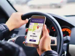 Ride share driver in car using the rideshare app in mobile phone. Pickup-Zone Crashes at Vegas Resorts