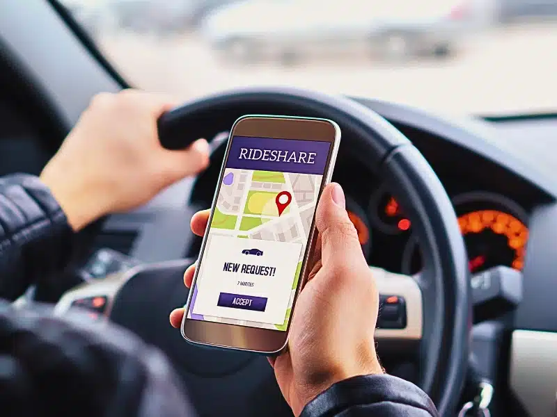 Ride share driver in car using the rideshare app in mobile phone. Pickup-Zone Crashes at Vegas Resorts