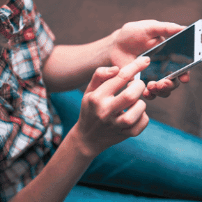 A person touching his cellphone insurance company use your social media